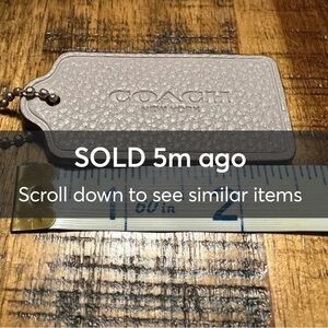 ‼️SOLD‼️Coach Taupe pebbled Leather Hang Tag.